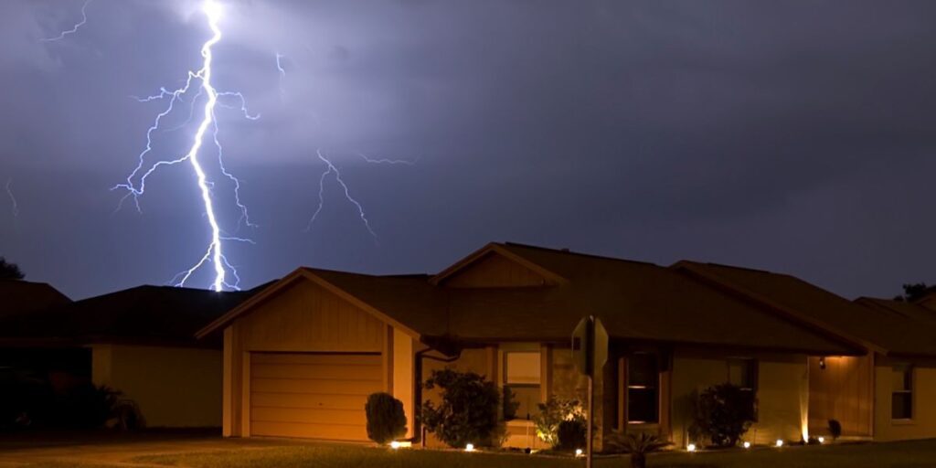 Lightning strike at night near homes